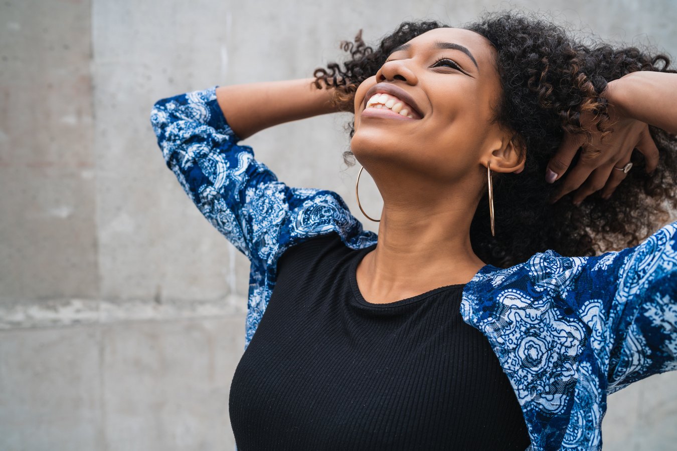 Happy Woman Touching Her Curly Hair